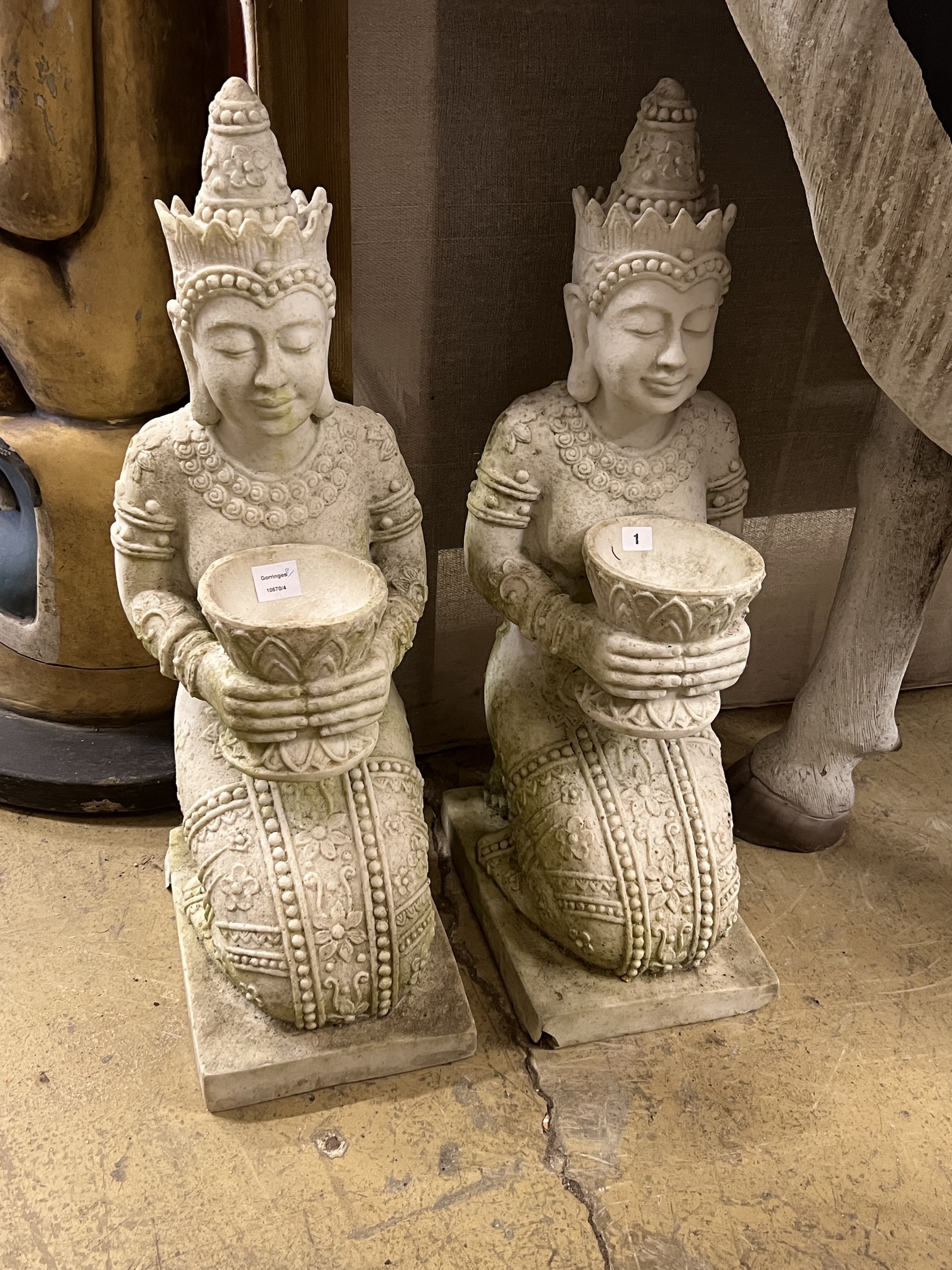 A pair of Thai style composition faux marble kneeling attendant garden ornaments, height 85cm